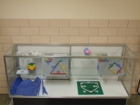 A display case exhibiting models demonstrating Lego math.